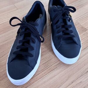 Adidas “sleek” women’s black leather casual sneaker.